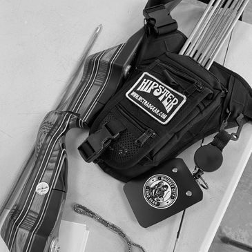 Black Hipster quiver loaded with arrows next to a Whiskey City scorecard holder